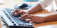 business, education, programming, people and technology concept - close up of african american female hands typing on keyboard